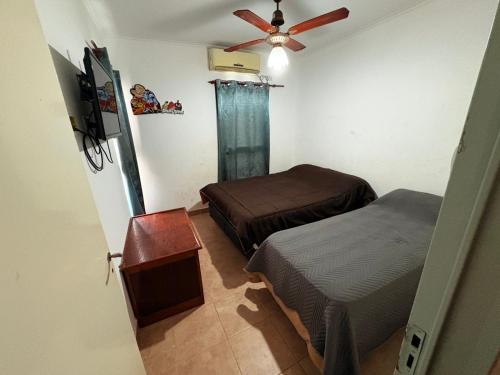 a bedroom with two beds and a ceiling fan at Duplex parque in Santiago del Estero