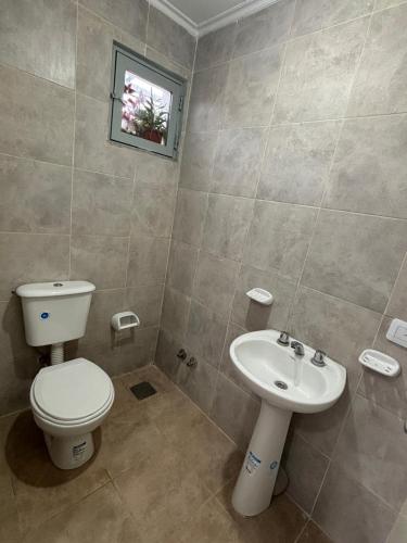 a bathroom with a toilet and a sink at Duplex parque in Santiago del Estero