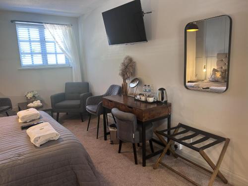 a bedroom with a desk and a bed and a mirror at The Red Lion & Cellar Room, Betchworth in Betchworth