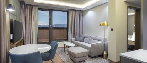 a living room with a couch and a table at Doubletree By Hilton Plovdiv Center in Plovdiv