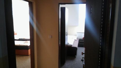 an open door to a room with a bedroom at Penzión U nás in Oravský Podzámok