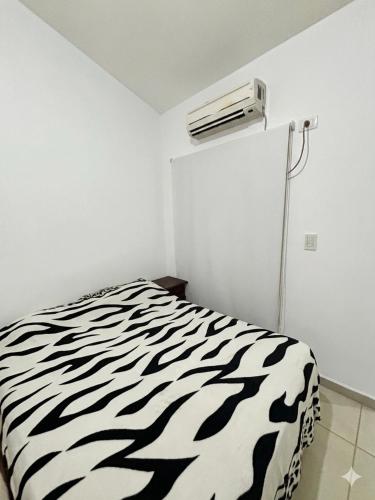 a black and white zebra print bed in a room at Duplex DEL CARMEN in Santiago del Estero