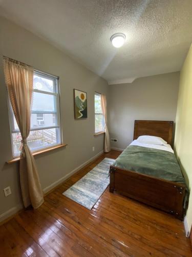 a bedroom with a bed and a window at The Hideaway in Cleveland
