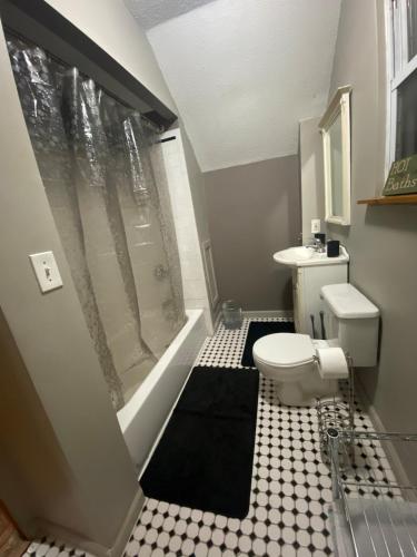 a small bathroom with a toilet and a shower at The Hideaway in Cleveland