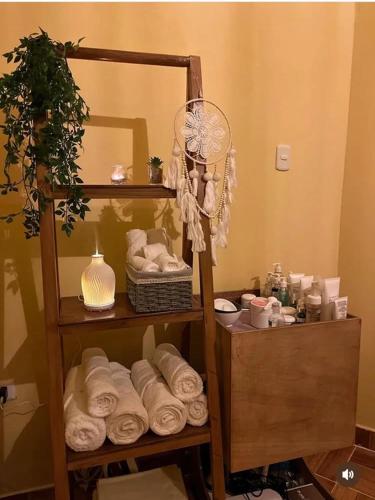 a room with a shelf with towels and a mirror at Hospedaje SAUNA & SPA NOAH in Bagua Grande