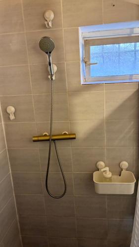 a shower with a shower head in a bathroom at Chalet paisible dans les Cévennes avec sauna privé in Dourbies