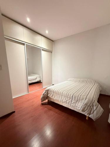 a bedroom with a bed in the corner of the room at Casa en planta alta in Rosario