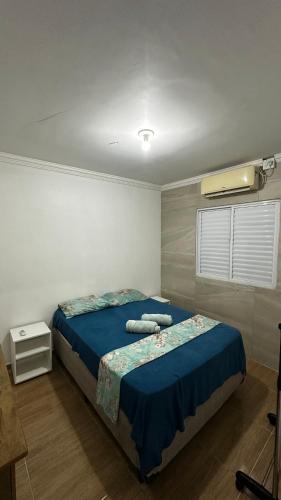 a bedroom with a bed with two towels on it at Flat Maracarib um espaço todo seu próximo de tudo in Maragogi