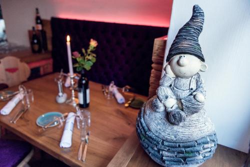 a table with a statue of a gnome on top of it at Hotel Restaurant Stöcklwirt in Sankt Johann im Pongau
