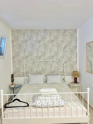 a white bed in a room with a wall at Mika Studio in Tivat