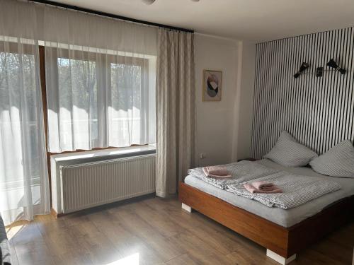 a bedroom with a bed and a window at Willa na Plażowej in Węgierska Górka