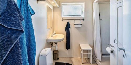 a small bathroom with a sink and a mirror at VE072-Vejers-Strand-Violvej-9 in Vejers Strand