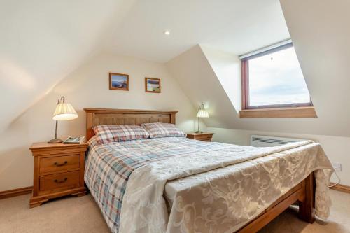 a bedroom with a bed and a window at 2 Bed in Lairg oc-75909 in Badcall
