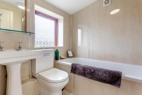 a bathroom with a toilet and a sink and a bath tub at 2 Bed in Lairg oc-75909 in Badcall