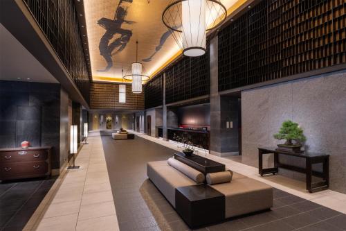 a lobby of a hotel with a couch and a table at DoubleTree by Hilton Kyoto Station in Kyoto