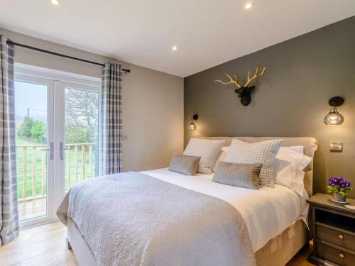 a bedroom with a large bed and a window at 1 Bed in Colne oc-86513 in Rawdon