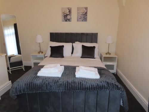 a bedroom with a large bed with two towels on it at Portman House in Middlesbrough