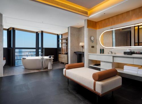 a bathroom with a bath tub and a sink at DoubleTree by Hilton Zhangzhou in Zhangzhou