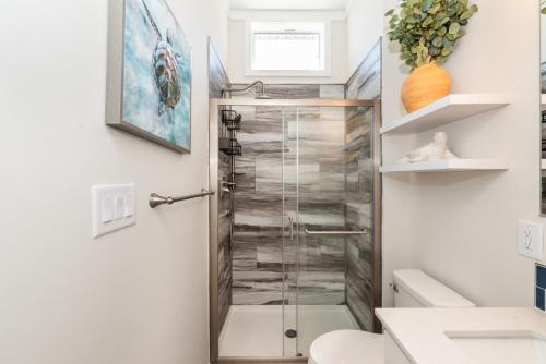 a bathroom with a shower with a glass door at Near Beach • Pool + Amenities • Sleeps 8 in Swain
