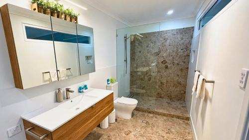 a bathroom with a toilet and a sink and a shower at Galley Cove House in Geographe