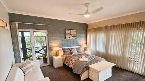 a bedroom with a bed and a window at Galley Cove House in Geographe