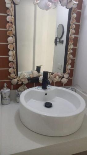 a white sink in a bathroom with a mirror at Mision del Sol 302 in Bahía Kino