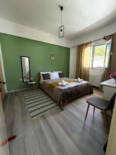 a bedroom with a bed and a green wall at Casa Verde in Marathias
