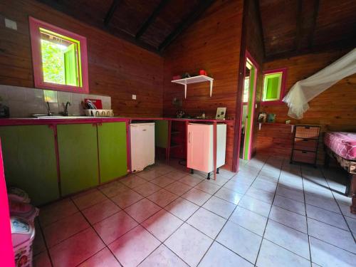 a kitchen with green and white appliances in a room at 3 Rivers Eco Lodge in Rosalie