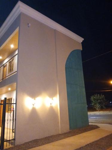 a building with lights on the side of it at night at Slan Ville Hotel in Chapadão do Sul
