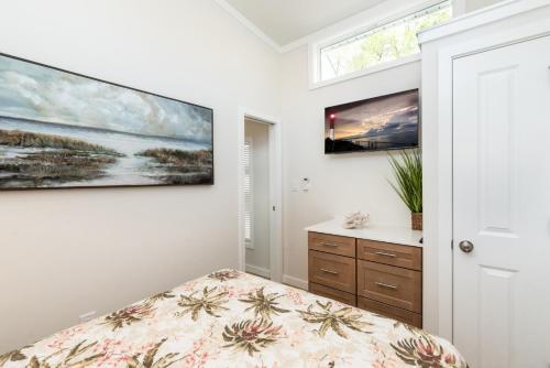 a bedroom with a bed and two paintings on the wall at Pool • Fire Pit • Amenities • Sleeps 8 in Swain