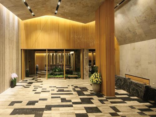 a lobby of a building with a checkered floor at South Urban Hotel in Chiayi City