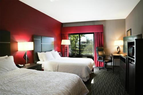a hotel room with two beds and a window at Hampton Inn & Suites Temecula in Temecula