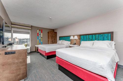 a hotel room with two beds and a sink at Hampton Inn Morgantown in Morgantown