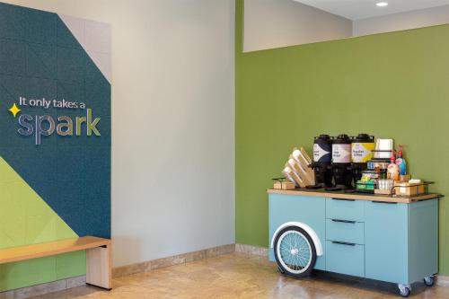 a cart in the corner of a room with a park sign at Spark by Hilton Tucson Reid Park in Tucson