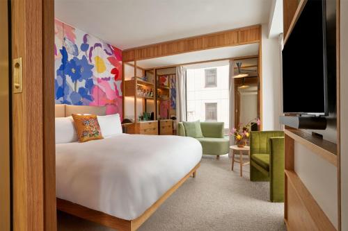 a hotel room with a bed and a tv at The BoTree London, Curio Collection by Hilton in London