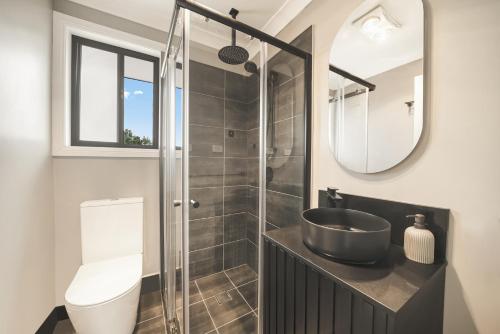 a bathroom with a sink and a shower at Pacific Palms Retreat - Entire Home in Plumpton Sleeps 9 - 8-Car Parking Near Eastern Creek in Rooty Hill