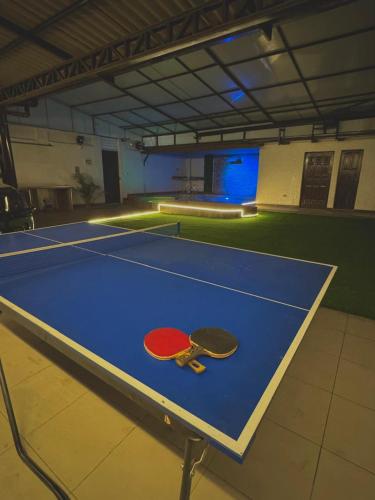 two tennis rackets sitting on a tennis court at TheBunker in Cochabamba