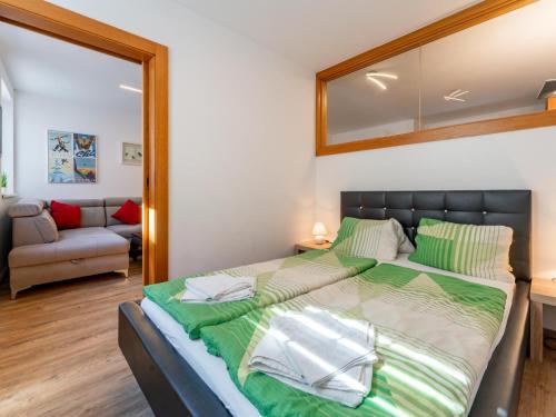 a bedroom with a large bed with a mirror at Selmas in Zell am See