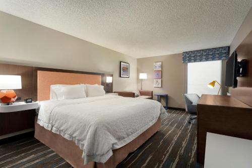 a hotel room with a bed and a desk at Hampton Inn Phoenix-Chandler in Chandler