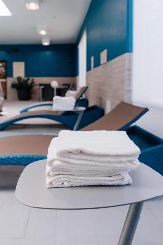 a stack of white towels sitting on a table at Hampton Inn Rehoboth Beach in Rehoboth Beach
