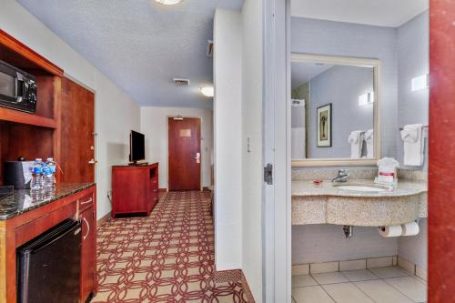 a hotel room with a bathroom with a sink at Hilton Garden Inn Starkville in Starkville