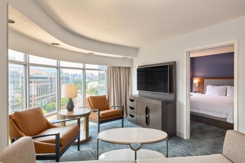 a hotel room with a bed and a flat screen tv at Hampton Inn Washington DC - Convention Center in Washington, D.C.