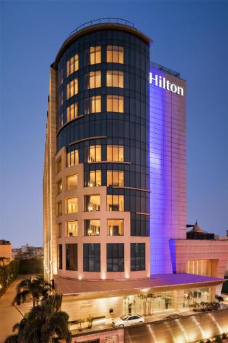 a tall building with a hilton sign on it at Hilton Jaipur in Jaipur