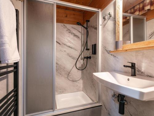 a bathroom with a shower and a sink at Bergzeit Hollersbach L in Hollersbach im Pinzgau