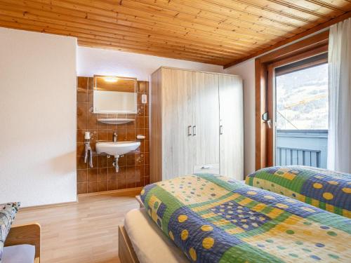 a bedroom with two beds and a sink and a mirror at Nachtschatt in Fügen