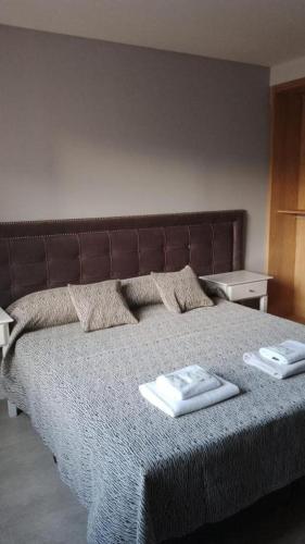 a bedroom with a bed with two towels on it at C&R Departamentos y Hoteles in Mar del Plata