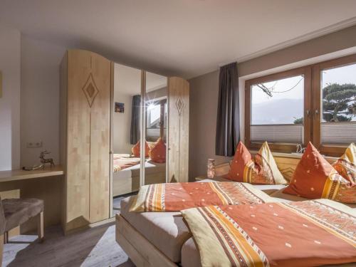 a hotel room with two beds and a mirror at Apartment Gartentraum in Itter