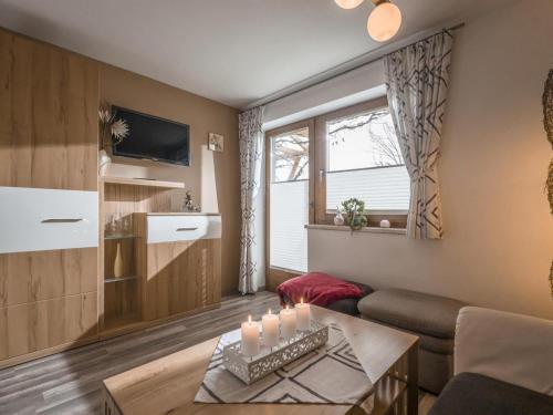 a living room with a couch and a table at Apartment Gartentraum in Itter