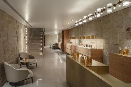 a kitchen with a bar and a table and chairs at Waldorf Astoria Jerusalem in Jerusalem