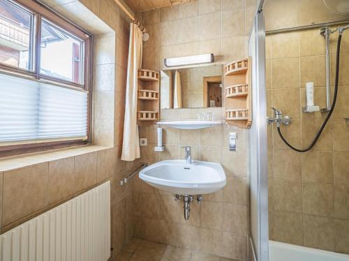 a bathroom with a sink and a shower at Maria Rose XXL in Kirchberg in Tirol